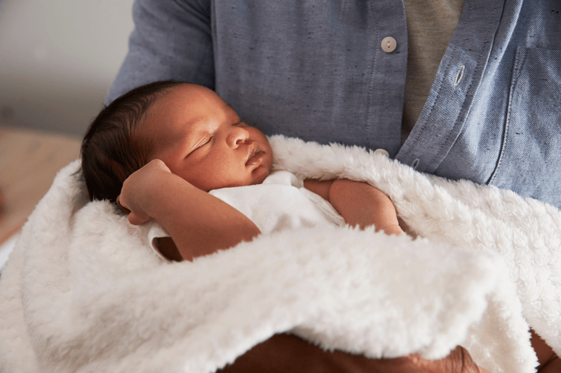 Person holding a baby.